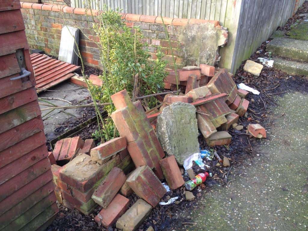 fence and brick wall damaged