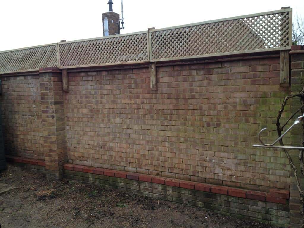 fence trellis installed on top of brick wall