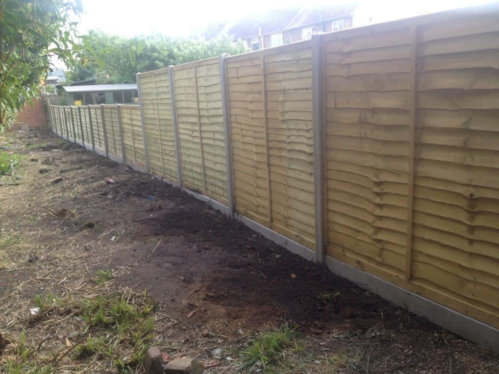 fence erection - concrete posts and concrete gravel boards with overlap panels