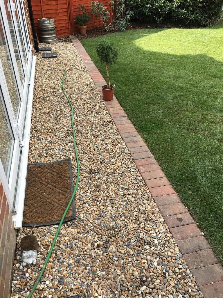 Laid new lawn, edged an area between gravel and lawn.