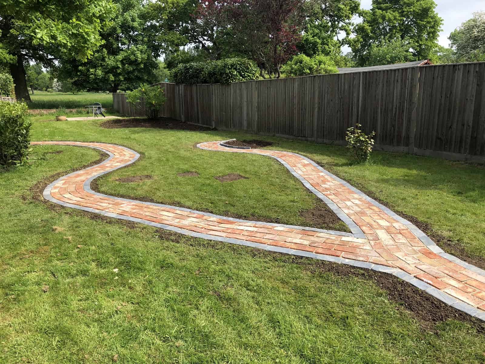 garden pathway made of slate edging stones and reclaimed bricks